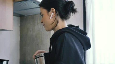 Free Stock Video Woman On Call With Earphones While Preparing Coffee Live Wallpaper - Free Live Wallpaper
