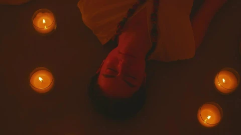 Free Stock Video Woman Meditating Lying On The Floor Between Some Candles Live Wallpaper - Free Live Wallpaper