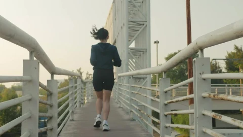 Free Stock Video Woman Jogging Across A Narrow Footbridge Live Wallpaper - Free Live Wallpaper