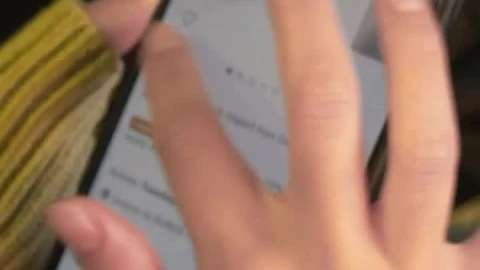 Free Stock Video Woman Exploring An Online Sales Page On Her Cell Phone Live Wallpaper - Free Live Wallpaper