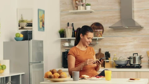 Free Stock Video Woman Checking Cell Phone During Breakfast Live Wallpaper - Free Live Wallpaper