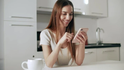 Stock Footage Woman Checking Facebook On Mobile Smiles Live Wallpaper - Free Live Wallpaper