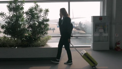 Stock Footage Woman Chatting On The Phone At An Airport Live Wallpaper - Free Live Wallpaper