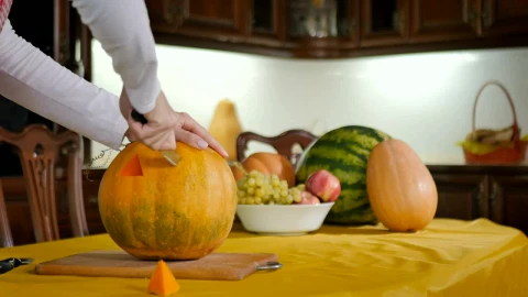 Stock Footage Woman Carves Pumpkin Into Jack O Lantern On Kitchen Table Live Wallpaper - Free Live Wallpaper