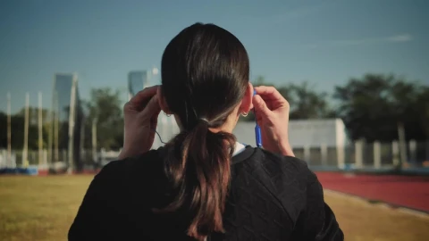 Stock Footage Woman Adjusting Her Headphones To Start Running Live Wallpaper - Free Live Wallpaper