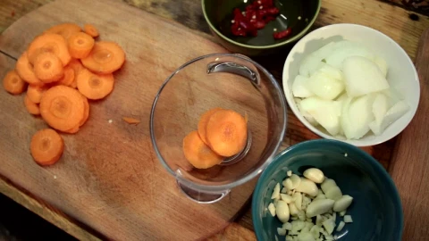 Stock Footage Woman Adding Chopped Carrots To A Bowl Live Wallpaper - Free Live Wallpaper