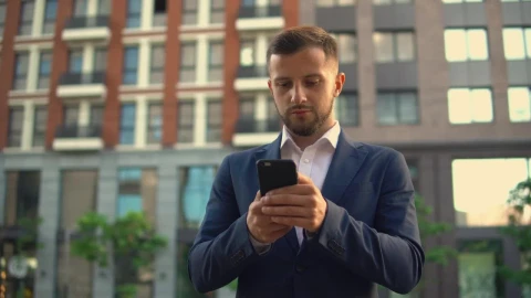 Stock Footage Well Dressed Businessman Sending Messages On His Cell Phone Live Wallpaper - Free Live Wallpaper