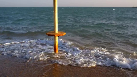 Stock Footage Waves Breaking Around An Umbrella Live Wallpaper - Free Live Wallpaper