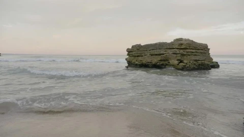 Stock Footage Waves Breaking Against A Large Rock Live Wallpaper - Free Live Wallpaper