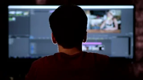Stock Footage Video Editor Working On A Large Screen Smalllive Wallpaper - Free Live Wallpaper