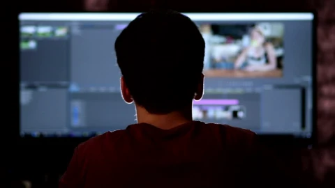 Stock Footage Video Editor Working On A Large Screen Live Wallpaper - Free Live Wallpaper