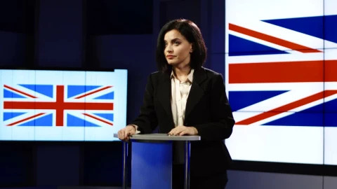 Stock Footage Young Woman Speaking With Uk Flag Behind Her Live Wallpaper Free - Free Live Wallpaper