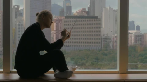 Stock Footage Woman Sitting By A Window With A Tablet Live Wallpaper Free - Free Live Wallpaper