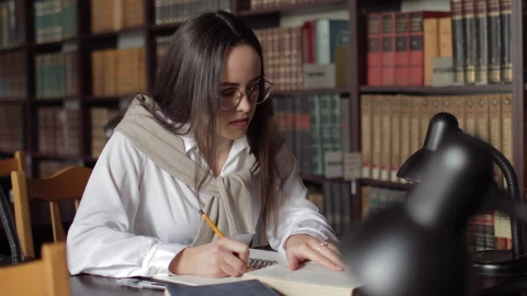 Stock Footage Woman Writing Her Homework In The Library Live Wallpaper Free - Free Live Wallpaper