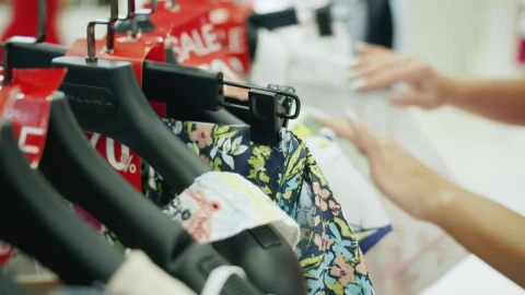 Stock Footage Woman Looking At Discounted Clothes Live Wallpaper Free - Free Live Wallpaper