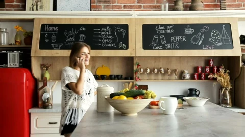 Stock Footage Woman Talking On The Phone In Her Kitchen Live Wallpaper Free - Free Live Wallpaper