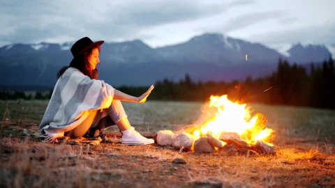Stock Footage Woman Warming Her Hands Over A Hot Campfire Live Wallpaper Free - Free Live Wallpaper