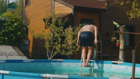 Stock Footage Young Man Jumping To An Inflatable Pool Live Wallpaper Free - Free Live Wallpaper