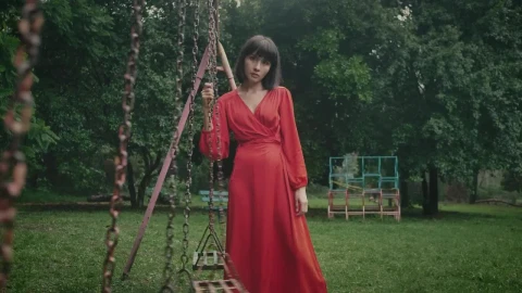 Stock Footage Woman In Red Holding A Swing In An Abandoned Park Live Wallpaper Free - Free Live Wallpaper