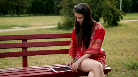 Stock Footage Woman Using Her Tablet In The Park Live Wallpaper Free - Free Live Wallpaper