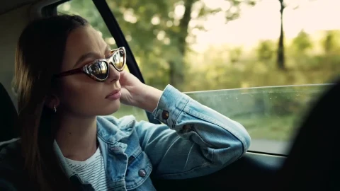 Stock Footage Woman In Denim Jacket Gazes Out Car Window Live Wallpaper Free - Free Live Wallpaper