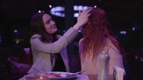 Stock Footage Woman Kisses Friends Forehead In Restaurant Live Wallpaper Free - Free Live Wallpaper
