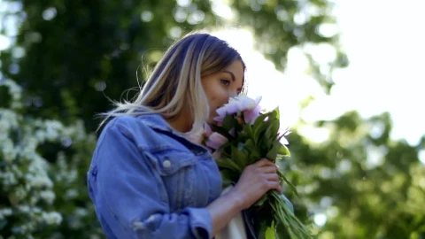 Stock Footage Woman In Denim Jacket Smelling Flowers On Spring Day Live Wallpaper Free - Free Live Wallpaper