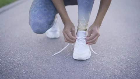 Stock Footage Woman Tying The Laces Of Her Sneakers Live Wallpaper Free - Free Live Wallpaper