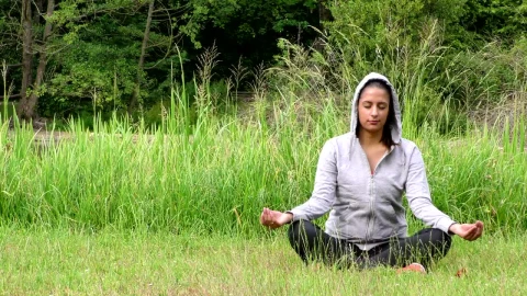 Stock Footage Woman In Hoodie Meditating On The Grass Live Wallpaper Free - Free Live Wallpaper