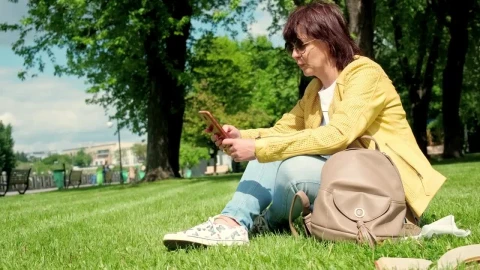 Stock Footage Woman Texting On Social Media In The Park Live Wallpaper Free - Free Live Wallpaper