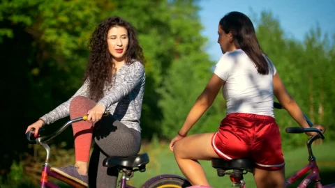 Stock Footage Young Women In Bikes Talking In The Park Live Wallpaper Free - Free Live Wallpaper