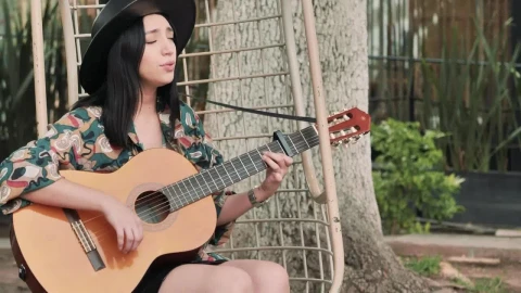 Stock Footage Young Woman Playing Guitar And Singing In A Garden Live Wallpaper Free - Free Live Wallpaper