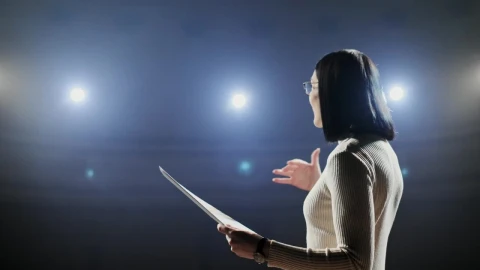 Stock Footage Woman Giving Motivational Talk On Dark Stage With Bright Lights Live Wallpaper Free - Free Live Wallpaper