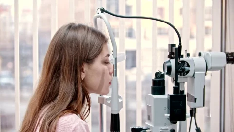 Stock Footage Woman Putting Chin On A Modern Vision Test Device Live Wallpaper Free - Free Live Wallpaper