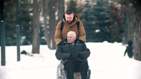 Stock Footage Young Man Walking With Grandfather In A Wheelchair Live Wallpaper Free - Free Live Wallpaper