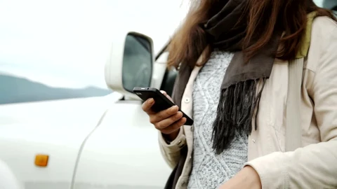 Stock Footage Woman Using Mobile Gps Outside Car Live Wallpaper Free - Free Live Wallpaper