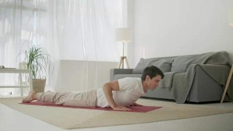 Stock Footage Young Man Doing Yoga Routine At Home In Living Room Live Wallpaper Free - Free Live Wallpaper