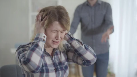 Stock Footage Woman Covers Ears While Man Yells In Background Live Wallpaper Free - Free Live Wallpaper