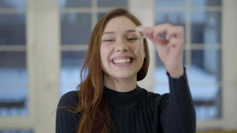 Stock Footage Young Woman Holds Up House Key With Big Smile Live Wallpaper Free - Free Live Wallpaper