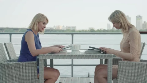 Stock Footage Women Look Over Menu At Bayside Restaurant Live Wallpaper Free - Free Live Wallpaper
