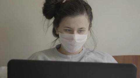Stock Footage Woman With Laptop In Face Mask Sneezes Live Wallpaper Free - Free Live Wallpaper