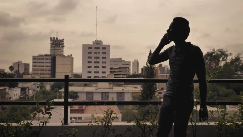 Stock Footage Young Man Having A Call On A Balcony Live Wallpaper Free - Free Live Wallpaper