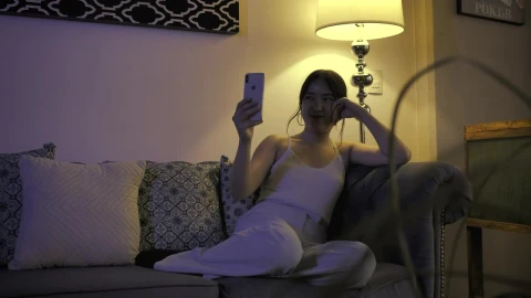 Stock Footage Woman Resting On A Sofa While Talking On Video Call Live Wallpaper Free - Free Live Wallpaper