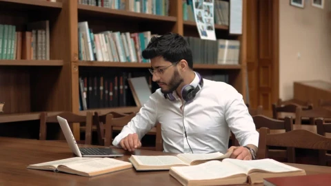 Stock Footage Woman Helping A Classmate With Homework In The Library Live Wallpaper Free - Free Live Wallpaper