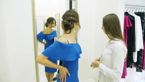 Stock Footage Woman Trying On A Dress In The Mall Live Wallpaper Free - Free Live Wallpaper