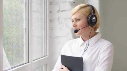 Stock Footage Woman Helping Customers Remotely By Bright Window Live Wallpaper Free - Free Live Wallpaper