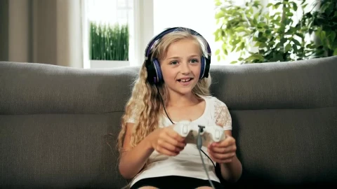 Stock Footage Young Girl Console Gaming On Sofa Cheers In Victory Live Wallpaper Free - Free Live Wallpaper