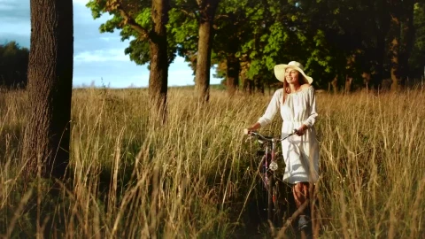 Stock Footage Woman Walking Bicycle Through Field Enjoys Afternoon Sun Live Wallpaper Free - Free Live Wallpaper