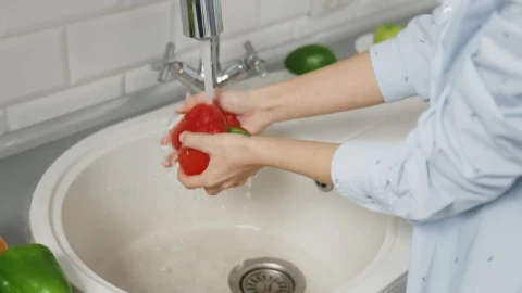 Stock Footage Woman Washes Red Pepper In Kitchen Sink Live Wallpaper Free - Free Live Wallpaper