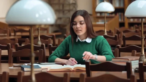 Stock Footage Woman Focused On Research In Library With Books Live Wallpaper Free - Free Live Wallpaper